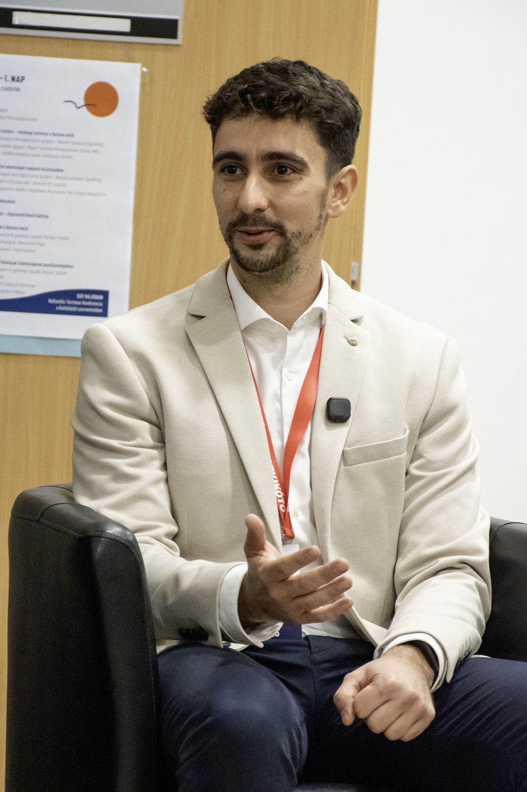 Adam Schmutz on the panel of the KULTKIKÖTŐ conference (Balatonföldvár, 2026) | Adam Schmutz gesturing while speaking on the KULTKIKÖTŐ conference panel | Adam Schmutz and Botond Boros (Visit Hungary) discussing tourism innovation at the KULTKIKÖTŐ conference | Botond Boros, Visit Hungary expert, on the panel at the KULTKIKÖTŐ conference | The audience of the KULTKIKÖTŐ conference during the panel | A question from the audience at the KULTKIKÖTŐ conference panel | KULTKIKÖTŐ – In the Same Boat Cultural Tourism Conference 2026 – conference badges