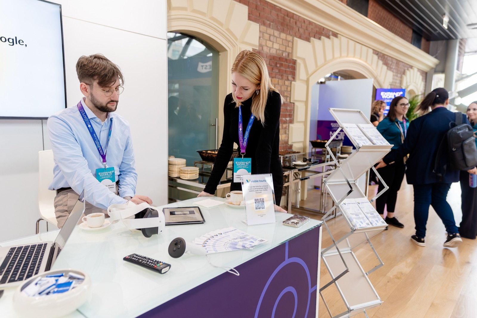 The Visible Tourism stand at Tourism Summit 2025 (Bálna, Budapest) – “Stay visible, stay relevant, stay on the map.” | The Visible Tourism team at the stand at Tourism Summit 2025 | The Visible Tourism team at the Tourism Summit 2025 stand | A professional conversation at the Visible Tourism stand at Tourism Summit 2025 | Adam Schmutz talking with a visitor at the Visible Tourism stand at Tourism Summit 2025